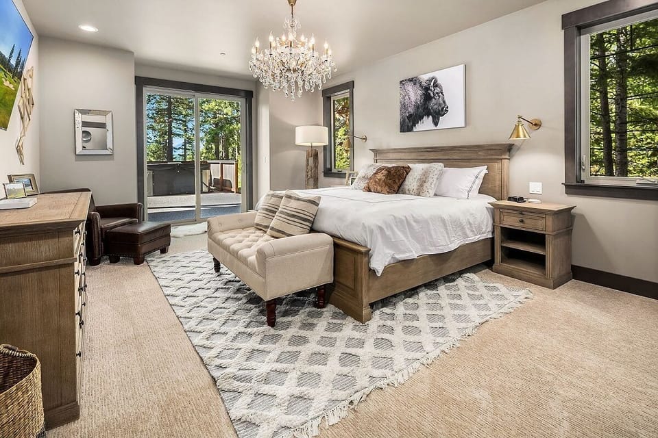 Main Floor – Bedroom 1: Master Suite with King Bed, Sitting Area, and Direct Deck Access.
