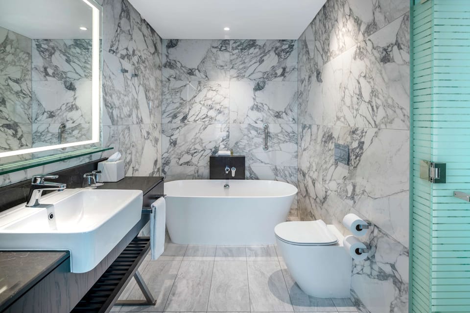 Deluxe Room, 1 King Bed (Plus) | Bathroom | Separate tub and shower, free toiletries, hair dryer, bathrobes