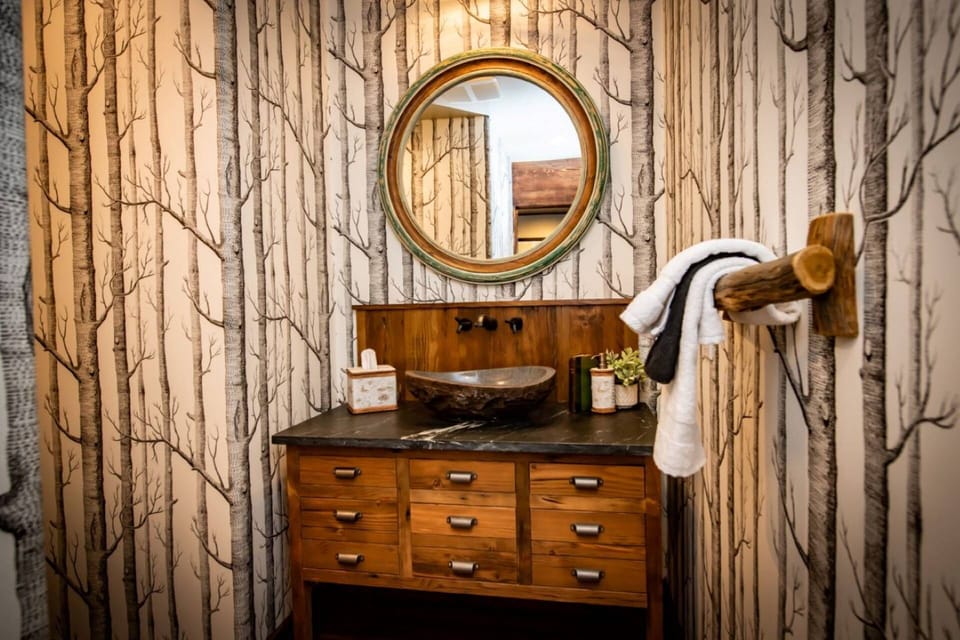 Unique Design Half Bath Near Living/Kitchen Area and garage. This home sleeps 8 and has 5 bedrooms and 4 bathrooms.
