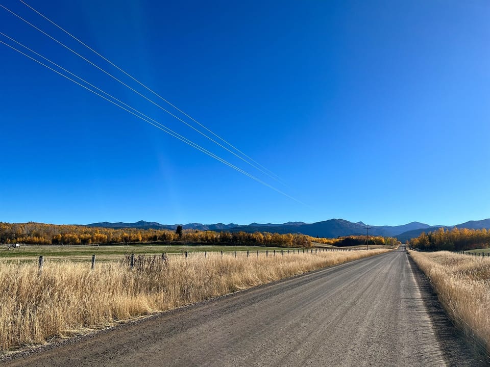 Our county road on approach, with the Tetons looming. The cabin, on the left, is one half mile from the state line and Wyoming.
