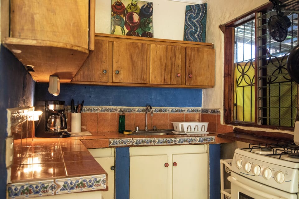 Wooden cabinetry and essential appliances make for a fully equipped-kitchen 