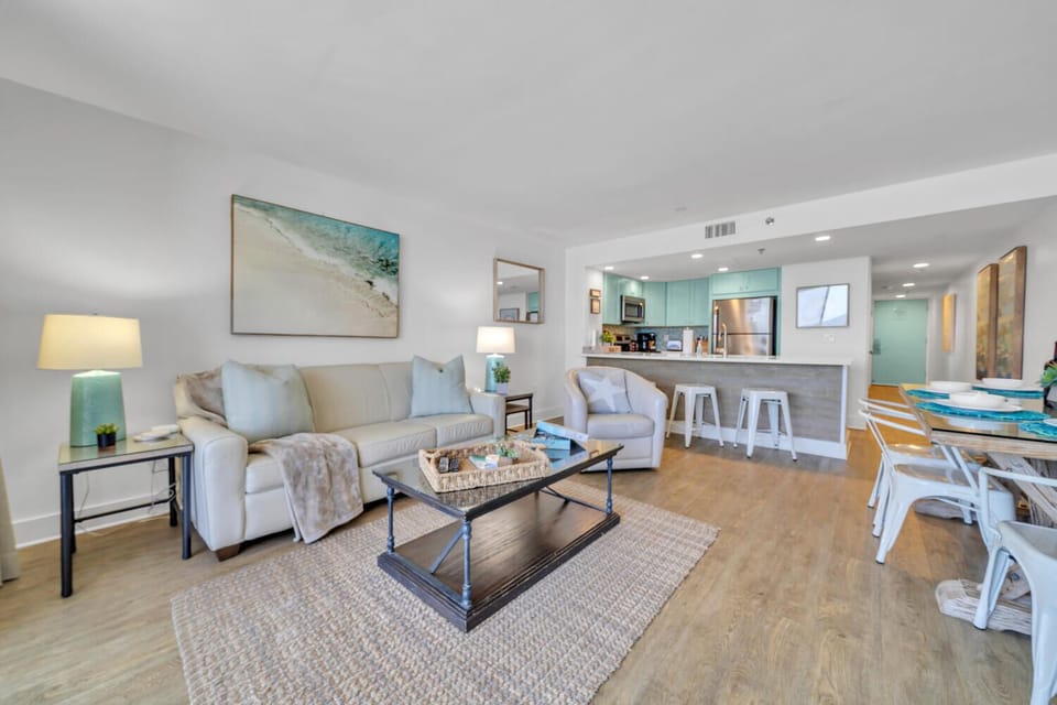 Relax in your bright coastal-themed living room, where soft seating and ocean-inspired decor create the perfect retreat after beach days.