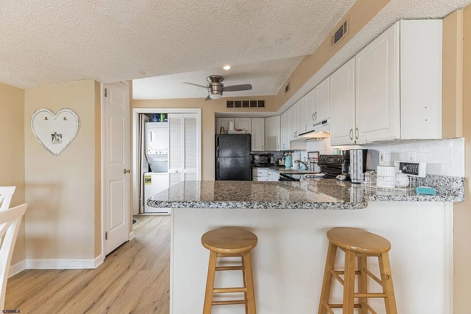 brand new countertops, fridge, cookware and tableware.