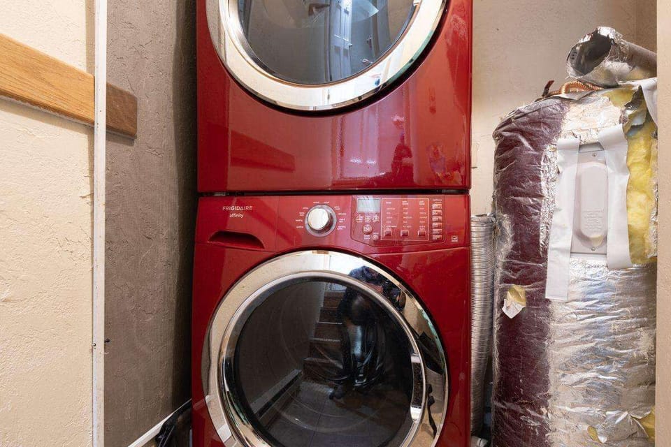 On the Entry Level of this unit is the laundry space with a stackable washer and dryer