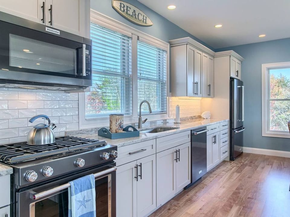 High end kitchen with gas stove and stainless steel appliances