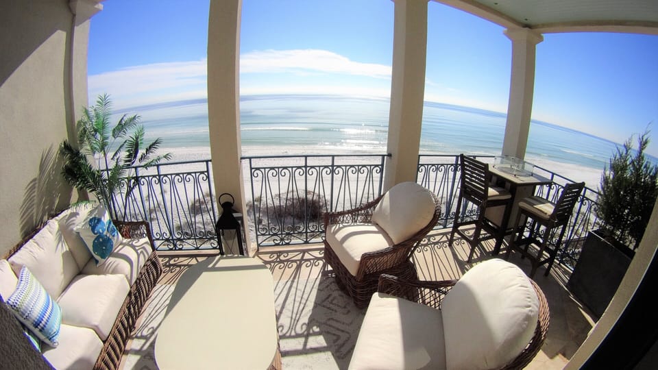 Second floor balcony with luxury furniture and plants.