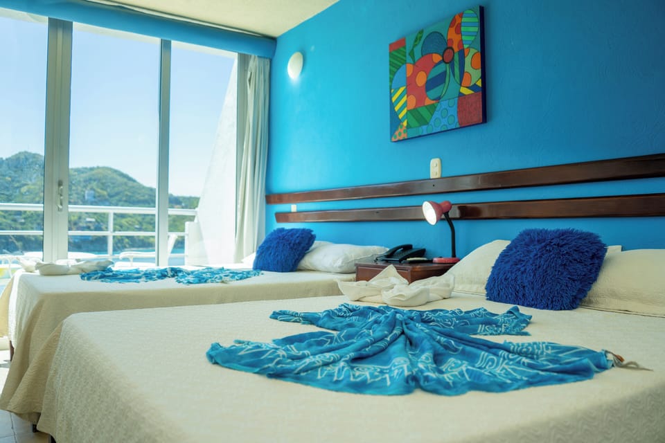 Deluxe Quadruple Room, Sea View | In-room safe, blackout drapes, WiFi (free), bed sheets