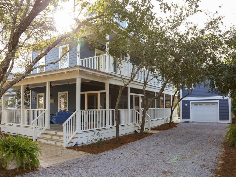 - Welcome to your dream coastal escape, wrapped in charm and southern style porches - Nestled under shady trees with a private driveway, peace and privacy await - Sip your morning coffee on the porch swing or unwind after a beach day