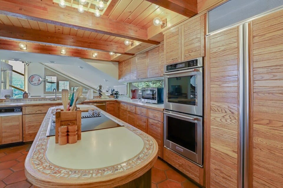 Fully stocked kitchen sharing a floor with the dining room