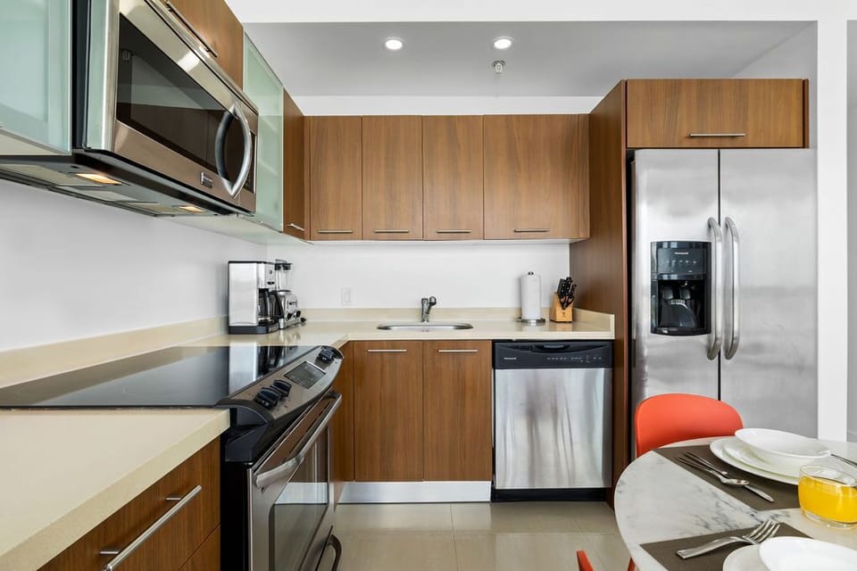 Your fully-equipped kitchen features sleek stainless steel appliances, warm wood cabinetry, and ample counter space to prepare your favorite meals during your stay.