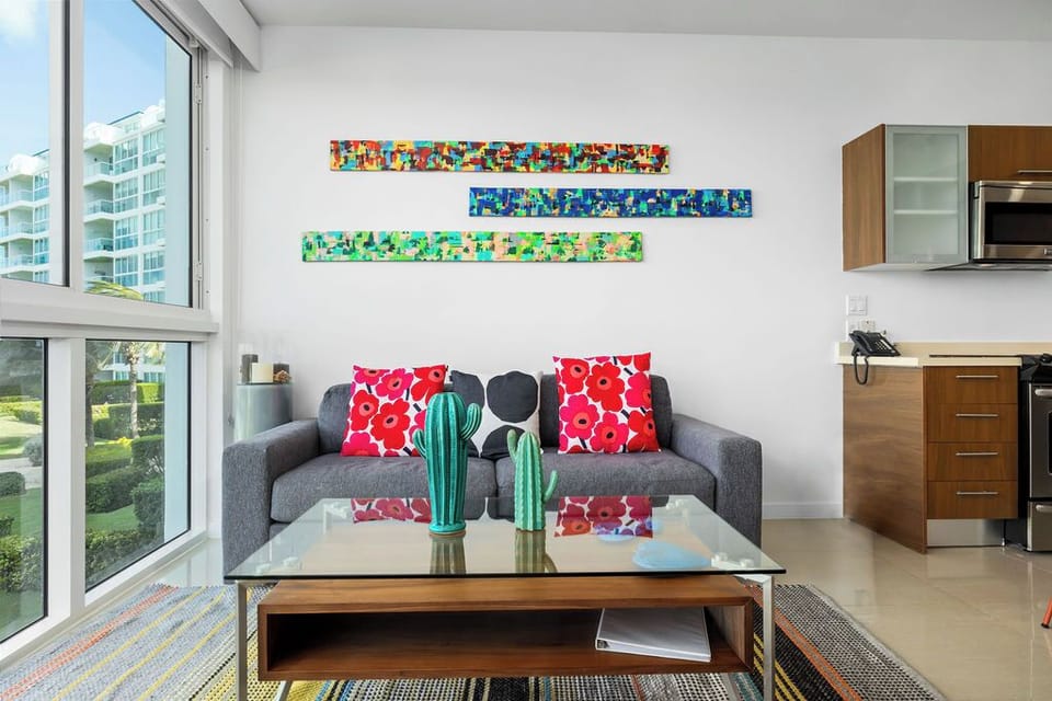 Relax in your bright, modern living space with vibrant artwork, plush seating, and a kitchenette stocked for your convenience.