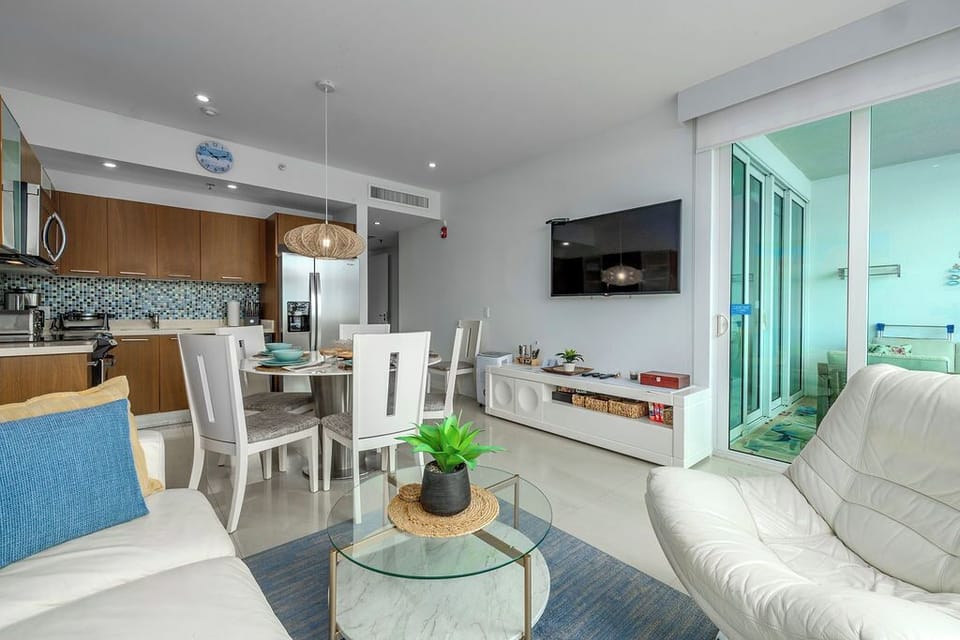 Relax in your bright, modern living space with stunning ocean views through floor-to-ceiling windows that invite natural light.