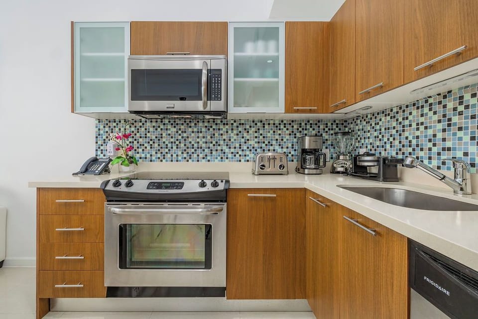 Your sleek kitchen awaits with modern appliances, beautiful mosaic backsplash, and everything you need to create delicious meals during your stay.