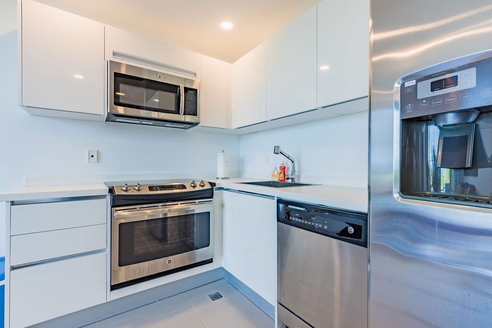 Sleek modern kitchen equipped with full-size appliances, ready for your culinary creations during your stay.