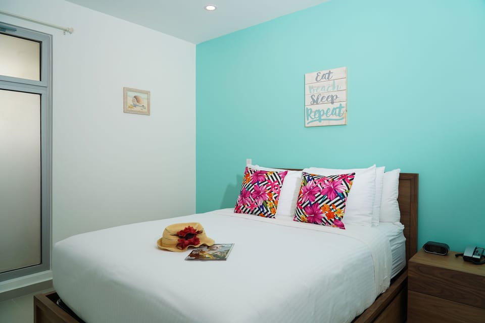 Your bright beach bedroom awaits with cheerful tropical vibes, crisp linens, and playful pops of color—perfect for unwinding after a day by the shore.