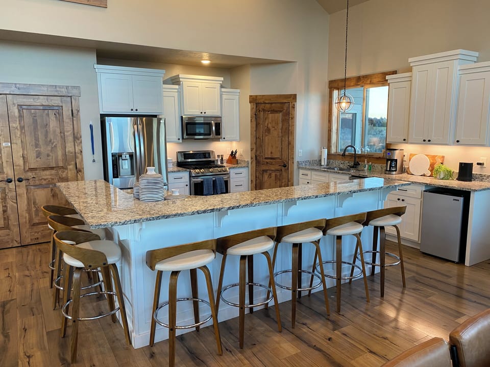 Stainless steel appliances, waffle irons, and electric griddles in the kitchen.