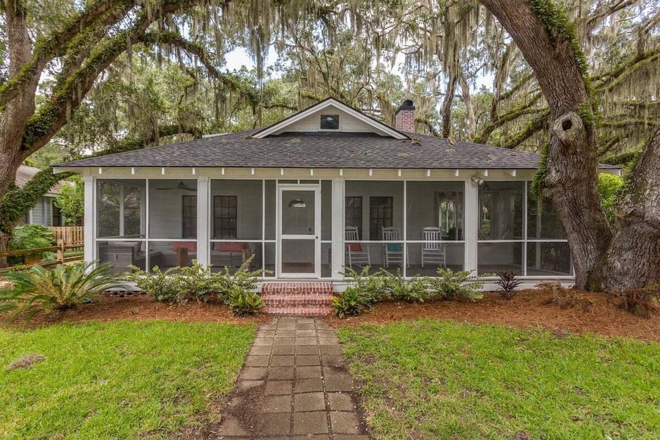 Front property exterior with oak trees