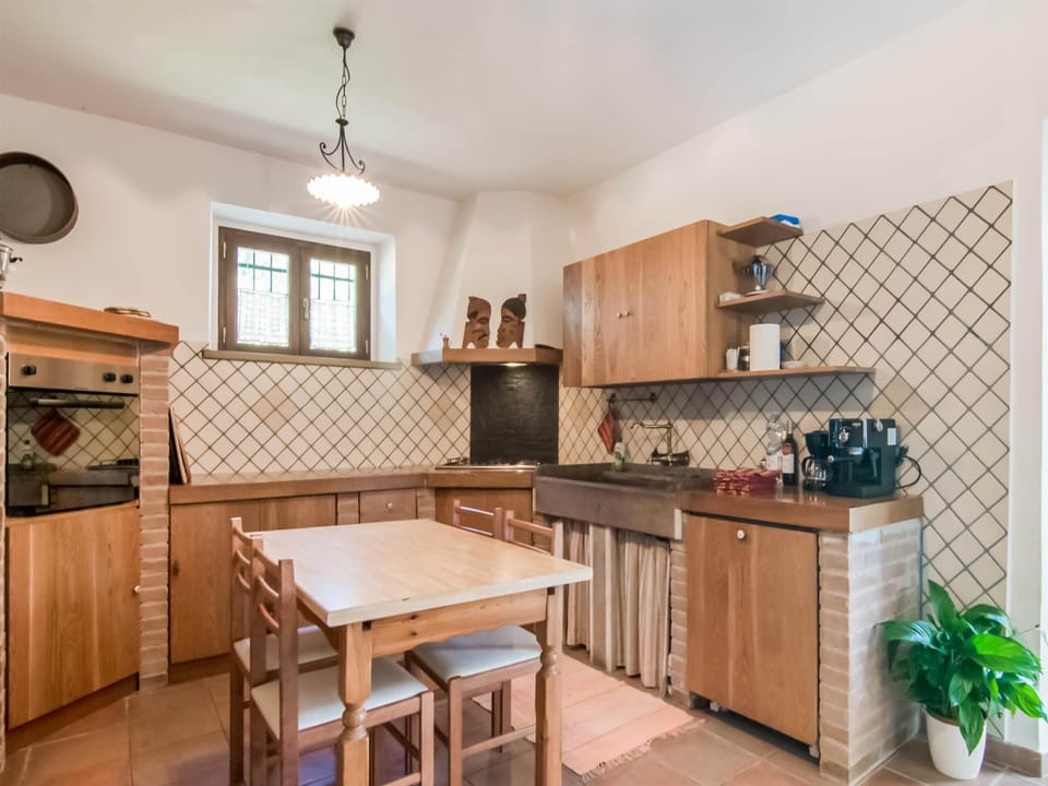 Villa | Private kitchen | Highchair, dining tables