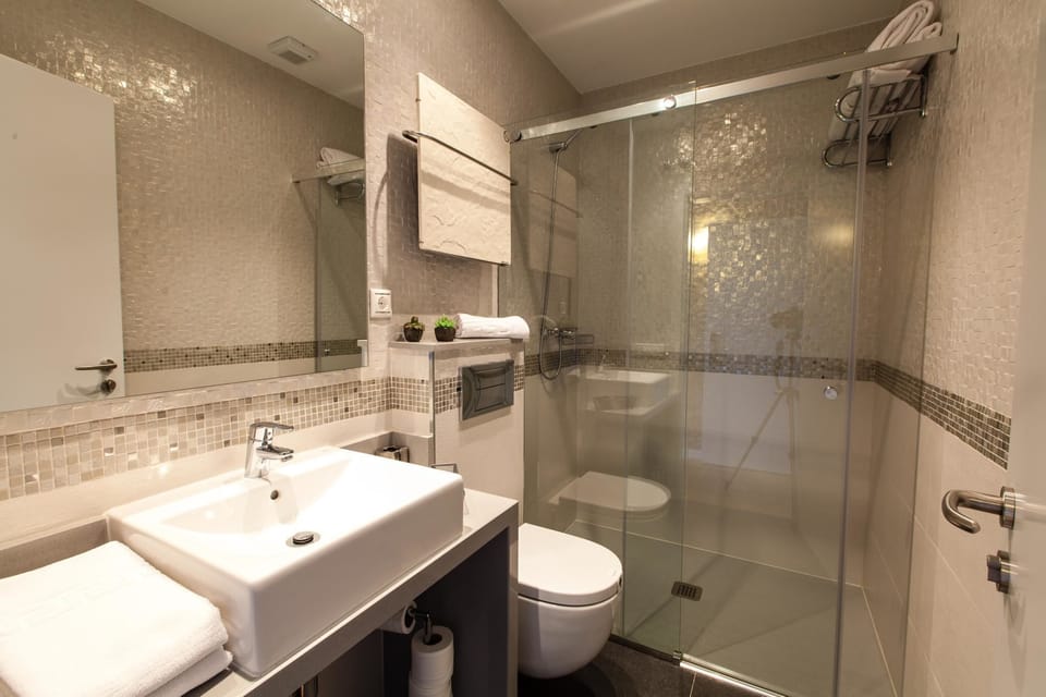 Shower, designer toiletries, hair dryer, towels