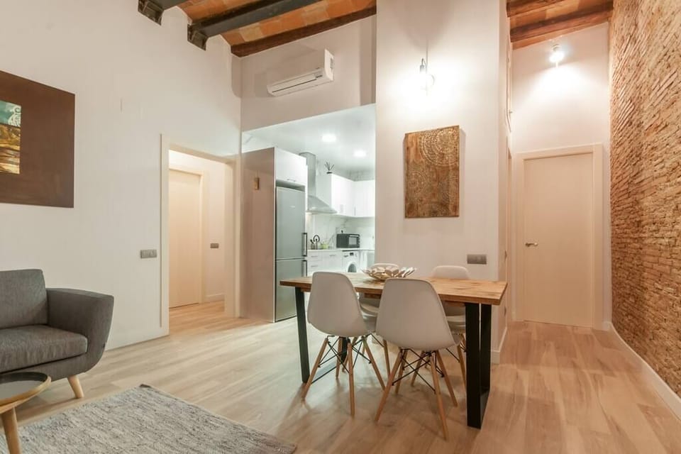 Living room, dining table with big windows, sofa, tv, and french balcony 