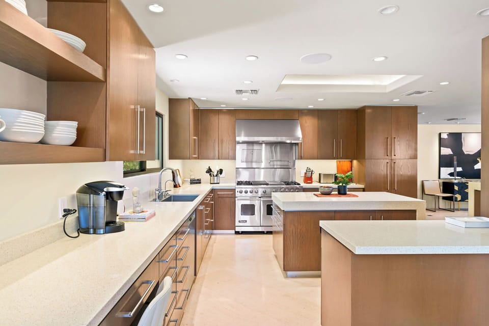 Gas range, large center island and seating for 3 at the bar