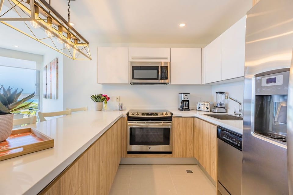 Your fully-equipped kitchen features modern stainless steel appliances, sleek countertops, and all the essentials for preparing meals during your stay.