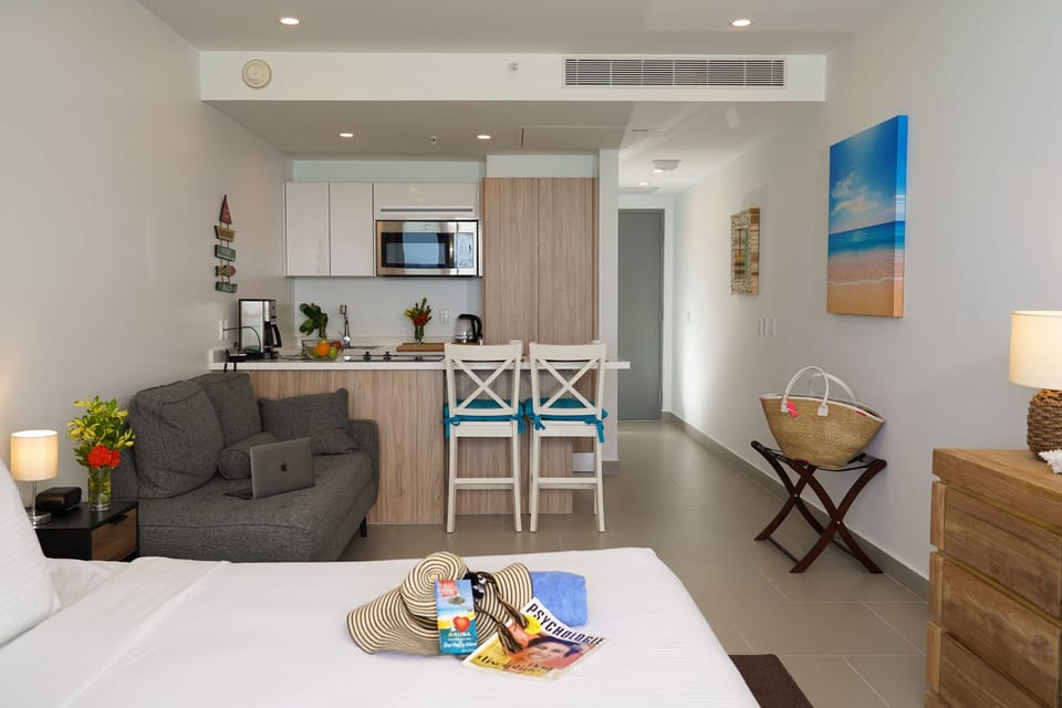 Step into your bright, modern studio where everything you need is thoughtfully placed. Relax on the cozy sofa, cook a quick meal, and unwind in comfort after your beach day.
