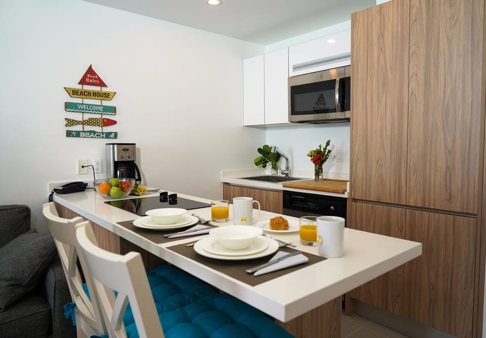 Your modern kitchen awaits, complete with sleek appliances, a breakfast bar for two, and fresh coffee ready to brew each morning as you plan your beach day.