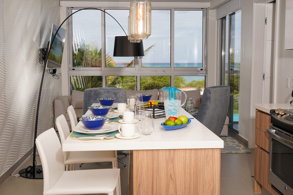 Gather around your dining table for meals with breathtaking ocean views framing every bite. The open-concept space blends style and comfort, inviting you to savor both the flavors and the scenery.