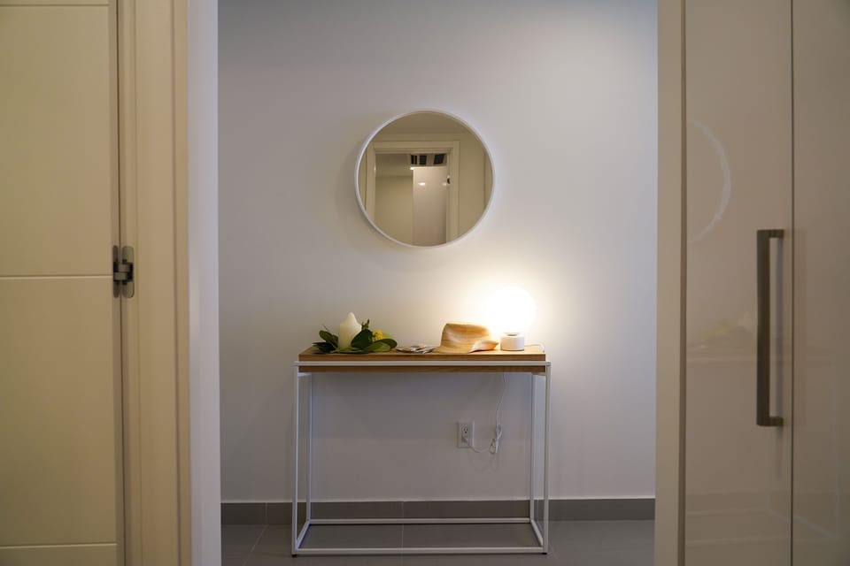 Your entry welcomes you with a minimalist console and round mirror, creating a bright and inviting first impression of your rental retreat.