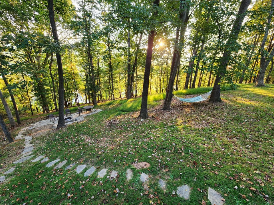 Backyard stone path to fire pit and view of river and Riverside Dr.