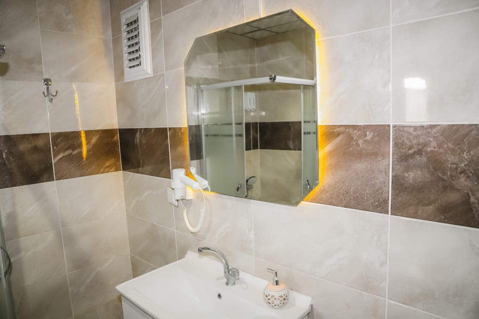 Shower, hair dryer, slippers, towels