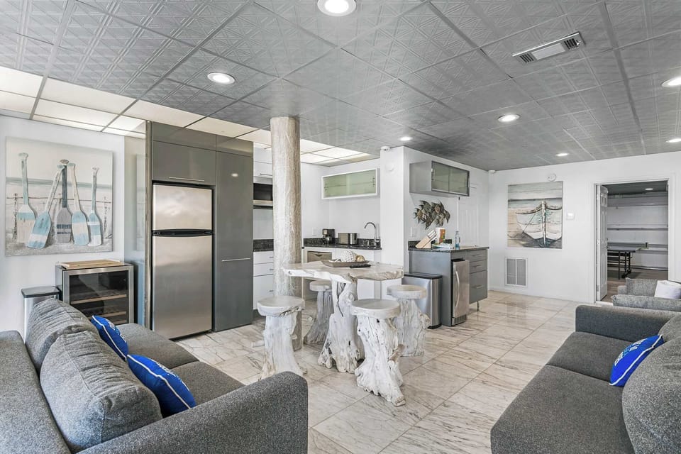 Open lounge area w/ seating, tile floors, & laid-back coastal feel.