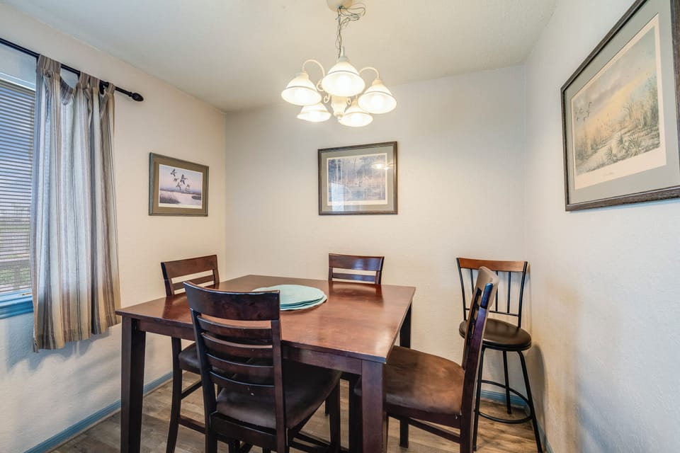 Gather around this elegant dining table for memorable meals together, with warm chandelier lighting creating the perfect atmosphere.