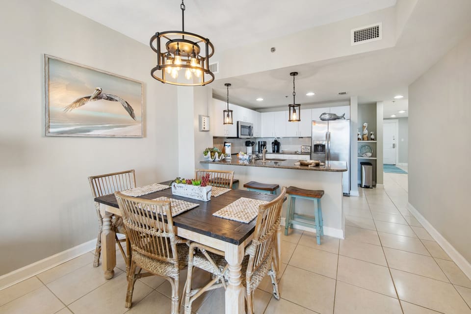You'll love sharing meals in this bright dining space with coastal charm and an open kitchen for easy entertaining.