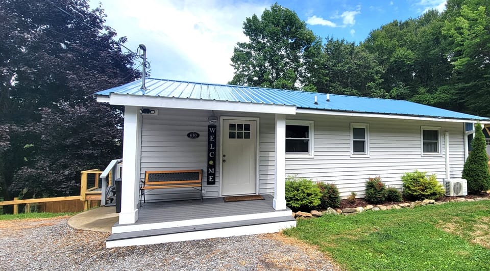 New blue roof and front porch welcome you to the property.