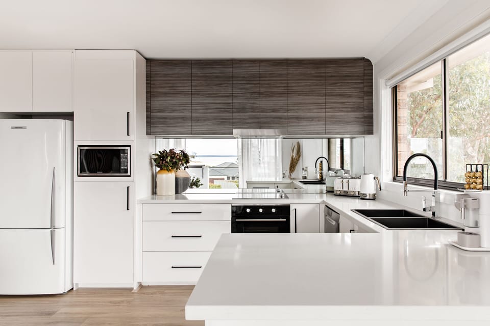 Full equiped kitchen with mirror splash back of the view.