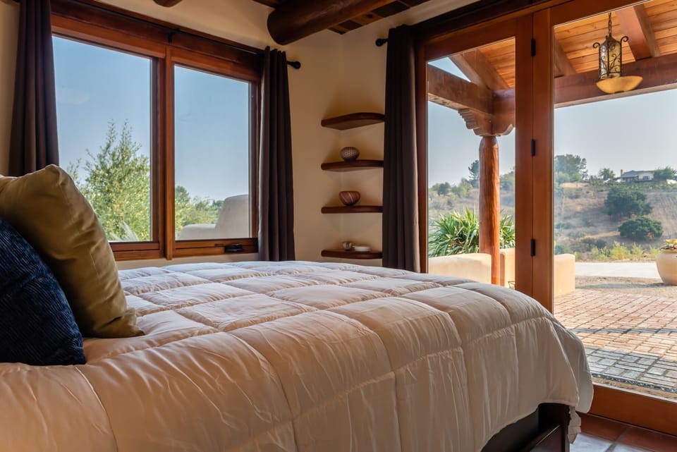 Guest bedroom with large picture windows.