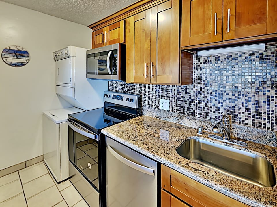 Enjoy a homecooked meal with everything you could need supplied in the condo kitchen.