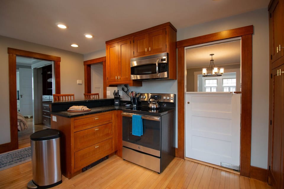 Fully equipped kitchen with all the essentials, including a standard coffee maker, dual toaster, dishwasher, dedicated ice maker, refrigerator, convection microwave, and electric stove.
