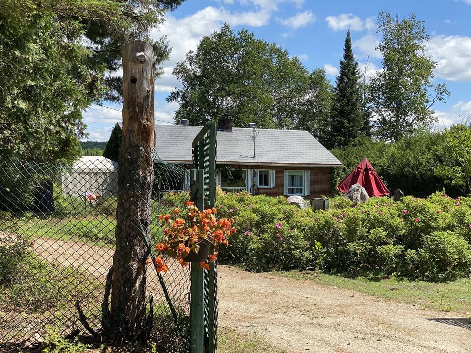 Exterior front with Garden and propane Fireplace