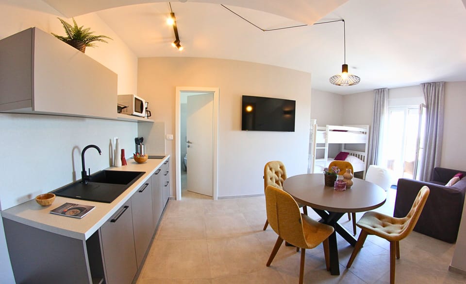 Family Room, Kitchenette | In-room safe, desk, free WiFi, bed sheets