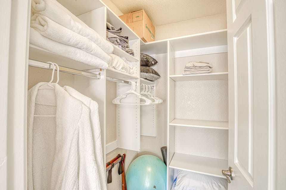 Second walk-in closet with two cozy robes