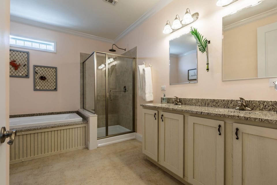 The large, updated en-suite bathroom in Bedroom 1 provides modern amenities and ample space for your comfort and convenience.