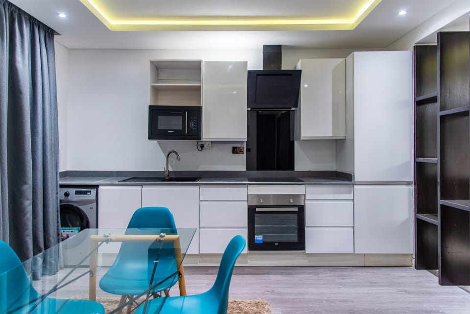 Executive Apartment, 2 Bedrooms, Pool Access | Private kitchen | Full-size fridge, microwave, cookware/dishes/utensils, cleaning supplies
