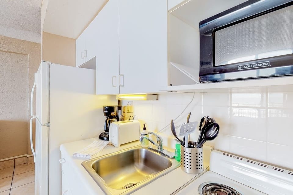 Kitchenette with pots & pans, utensils and everything you need to cook a meal.