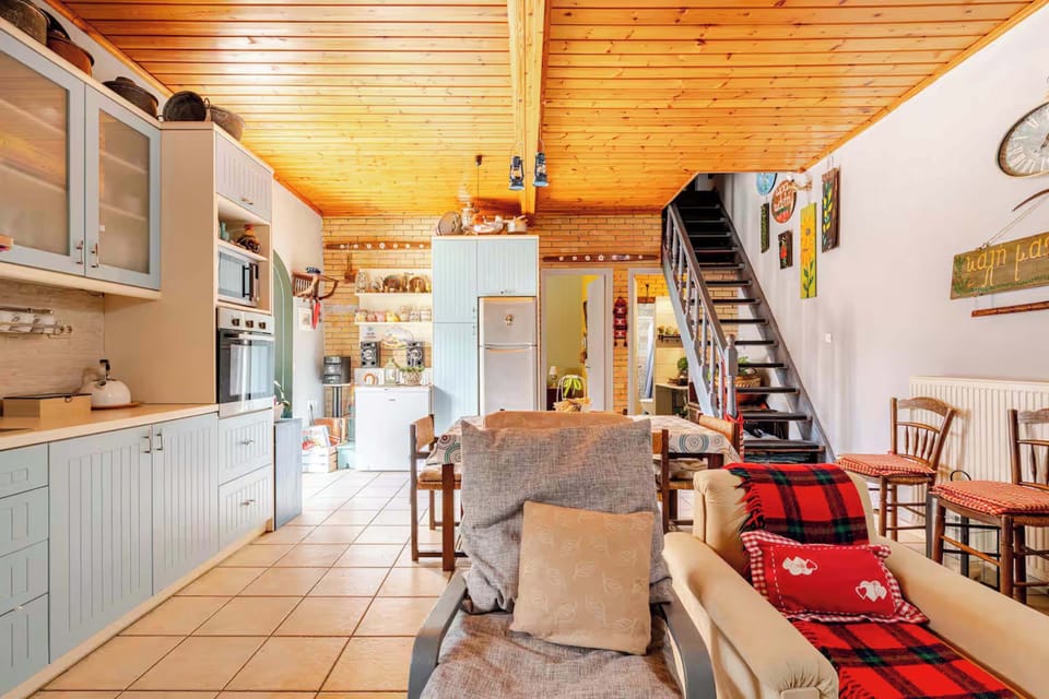 Dining Area & Staircase – Open-plan dining with six-seater table, wood accents, and staircase leading to upper floor bedrooms.