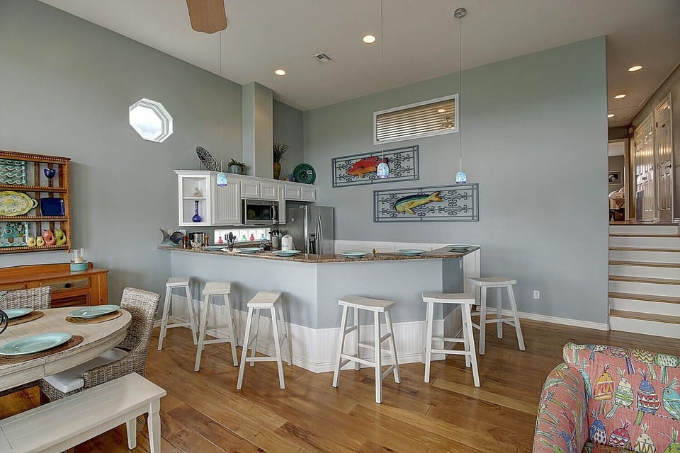 Kitchen - Step into this stylish coastal retreat featuring an open-concept kitchen and living area