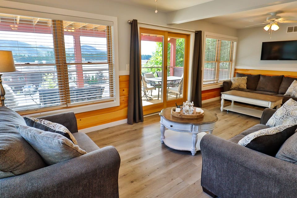 Spacious living room with a pull-out sofa bed and a sliding glass door.