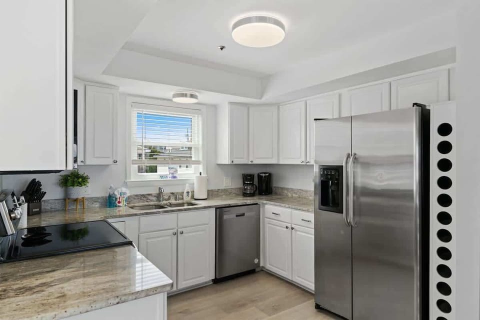 Kitchen: Whip up culinary delights in this modern kitchen with stainless steel appliances and natural light!